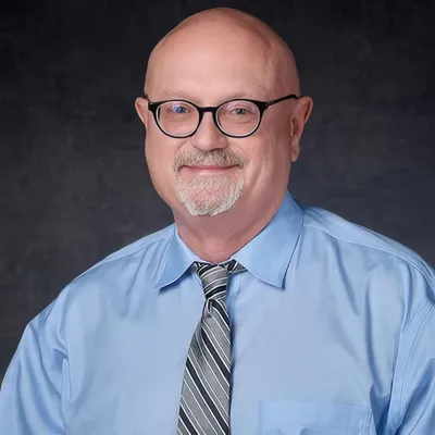 Experienced male addictionologist providing expert behavioral health care in bright medical office.