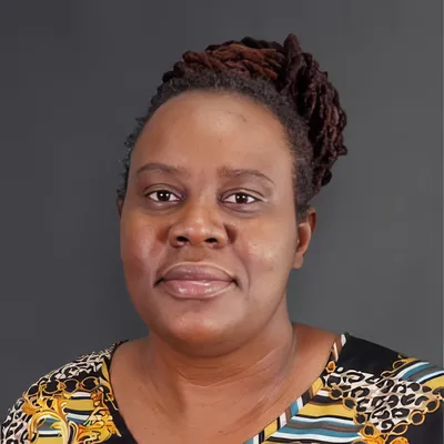 Experienced female family therapist facilitating open communication in clinical counseling office.