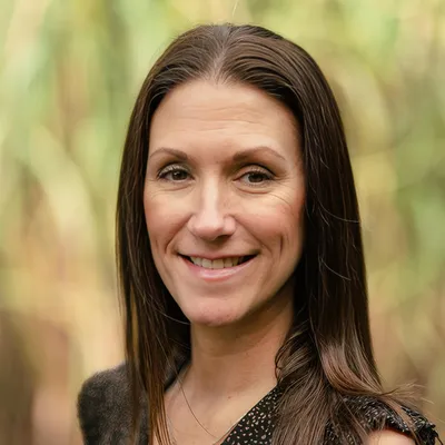 Female clinical director overseeing comprehensive treatment protocols in behavioral health center.