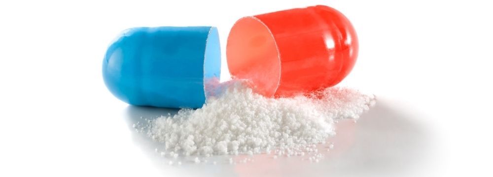 Prescription capsule opened with powder poured out before snorting