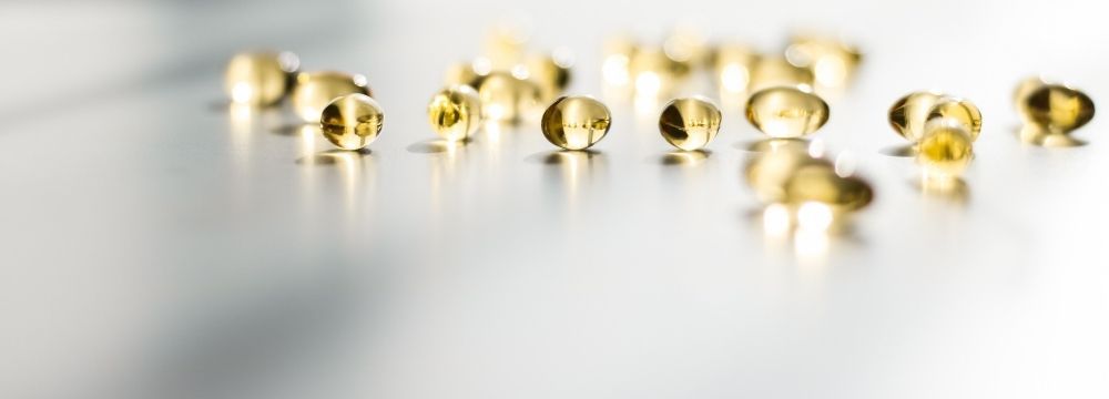 Vitamin D supplements set beside a window, sometimes used alongside psychiatric care for depression linked to vitamin D deficiency