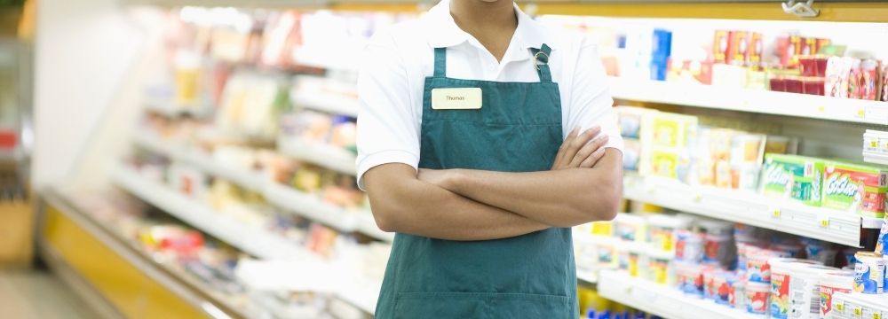 Young man works at a grocery store as he navigates life in recovery after treatment at Destination Hope for major depression, generalized anxiety disorder, and co-occurring substance use