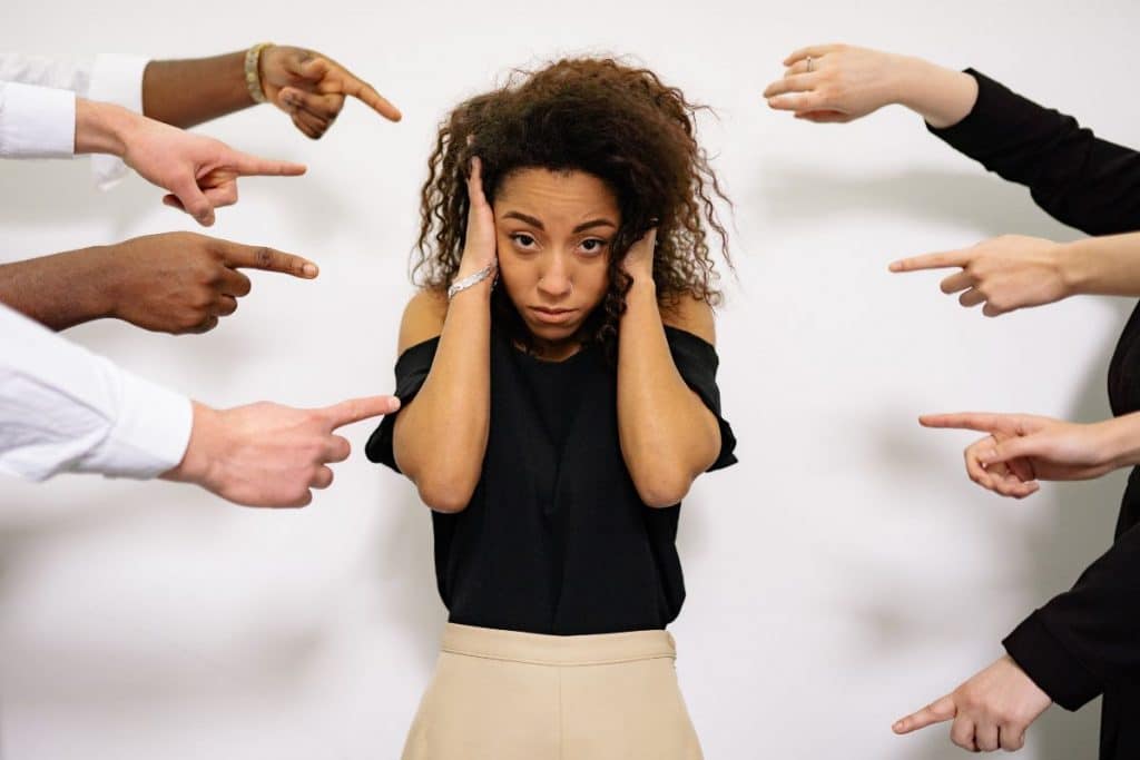 People pointing fingers at the stressed woman - destinationhope.com