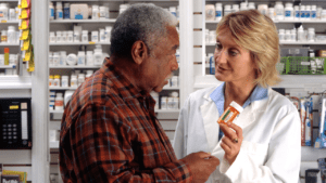 A man consulting with his pharmacist about a prescription drug