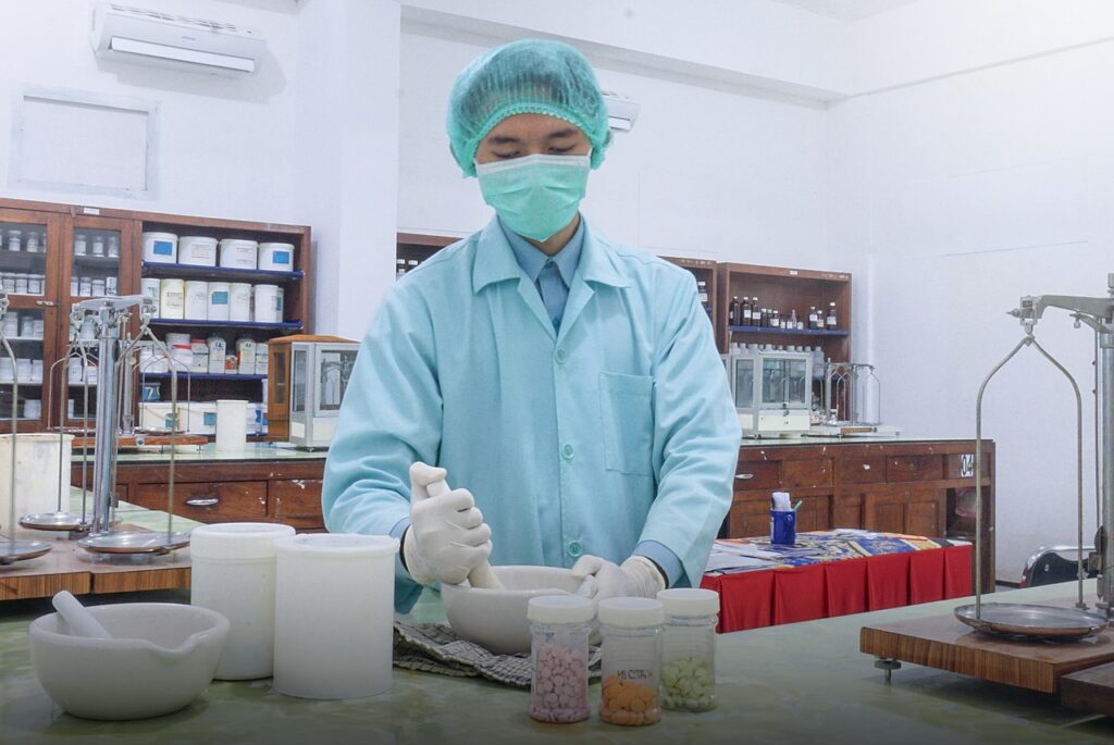 Assistant pharmacist mixing a medicine up for a patient