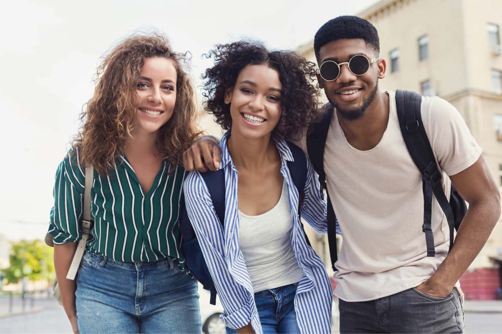 Three people smiling